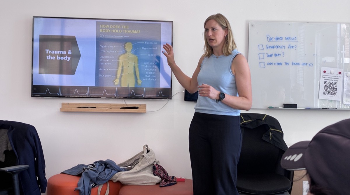 Dr Mareike Suesse presenting a trauma-informed training workshop at Fulham Reach Boat Club, with a slide on trauma and the body